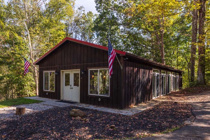 Pool house with American flags and red roof at High Point Lodge