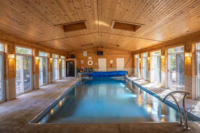 Indoor heated saltwater pool with windows on both sides at High Point Lodge