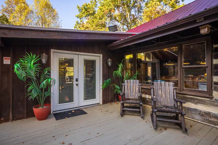 Front patio with French doors, palms and rocking chairs at High Point Lodge