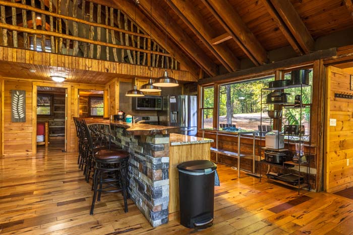 Kitchen with stone breakfast bar and bar stools at High Point Lodge