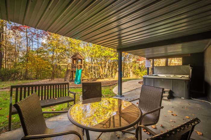 Patio table and chairs beside the covered hot tub at High Point Lodge