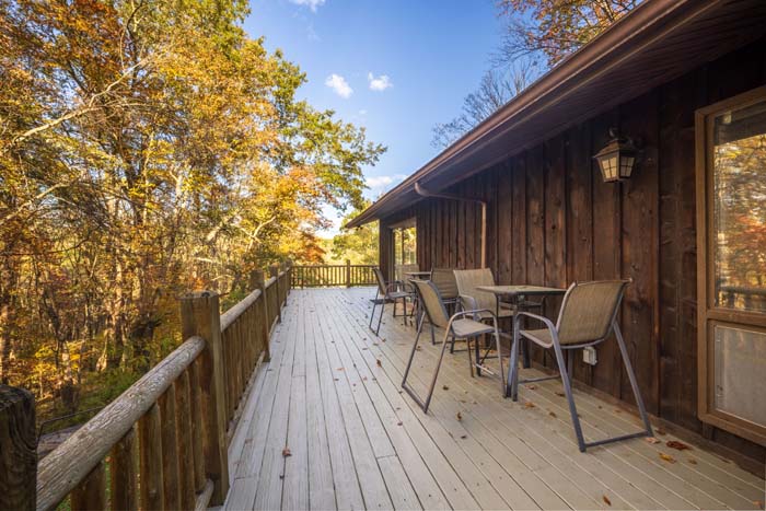 Deck with patio table and chairs among the trees at High Point Lodge