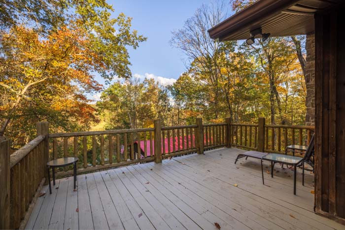 Deck with lounge chair overlooking fall trees at High Point Lodge