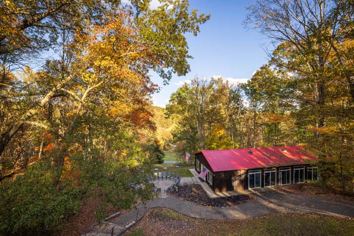 View from the deck to the pool house and fall woods at High Point Lodge