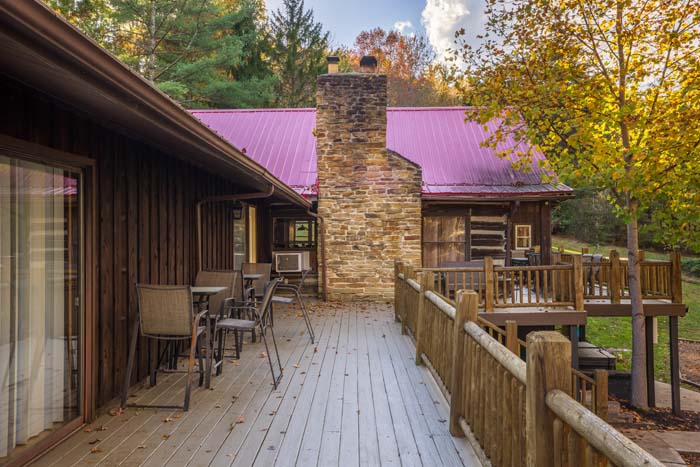 Deck with patio seating beside the stone chimney at High Point Lodge