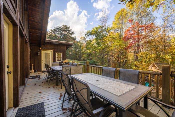 Deck with long outdoor dining table at High Point Lodge