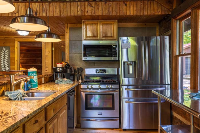 Kitchen with gas range, microwave and stainless refrigerator at High Point Lodge