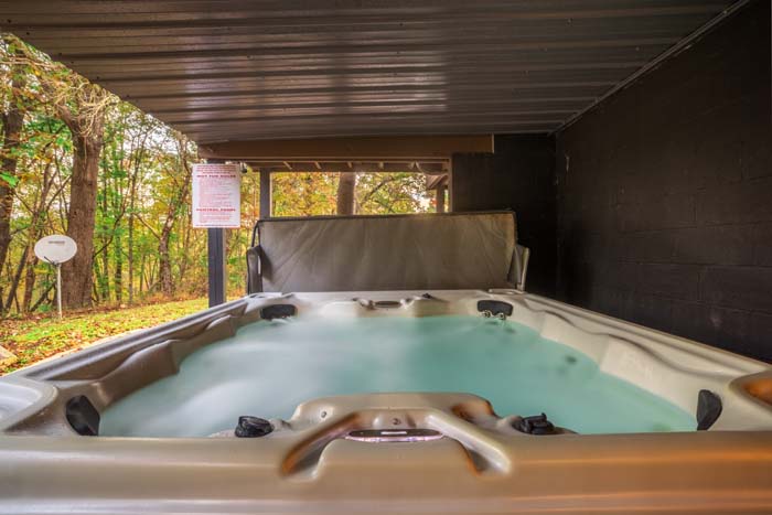 Covered hot tub overlooking the woods at High Point Lodge