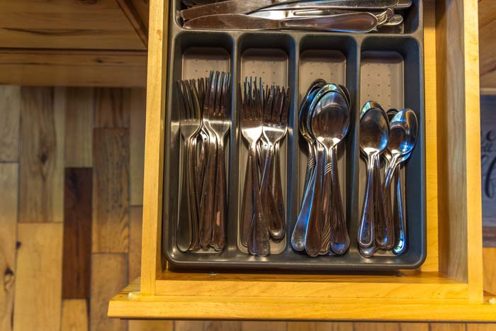 Silverware drawer stocked with forks, knives and spoons at High Point Lodge