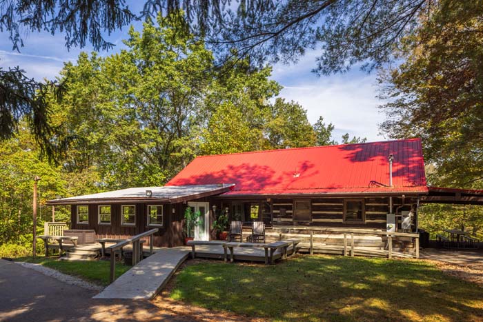 Red roof log cabin and wheelchair ramp at High Point Lodge
