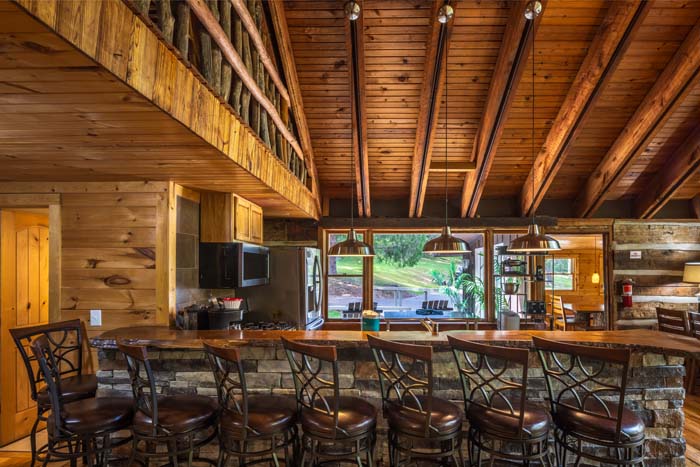 Long stone breakfast bar with bar stools under the loft at High Point Lodge