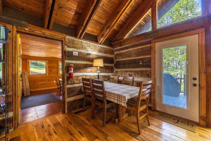 Dining table by a glass door in the log room at High Point Lodge