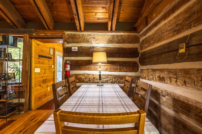 Dining table with plaid tablecloth in the hand hewn log room at High Point Lodge