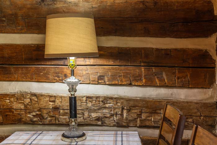Table lamp in front of the hand hewn log wall at High Point Lodge