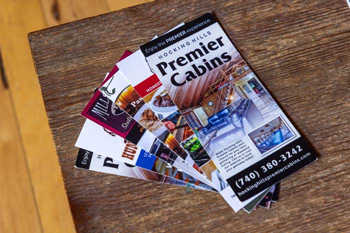 Hocking Hills Premier Cabins brochures on a wood table
