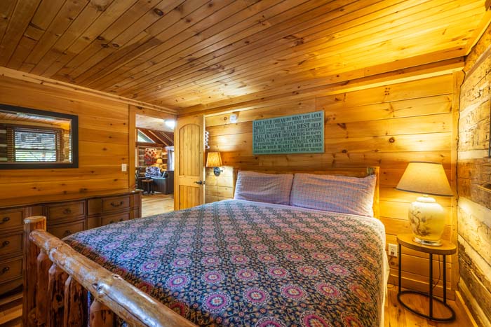 Bedroom with log bed, lamps and window at High Point Lodge