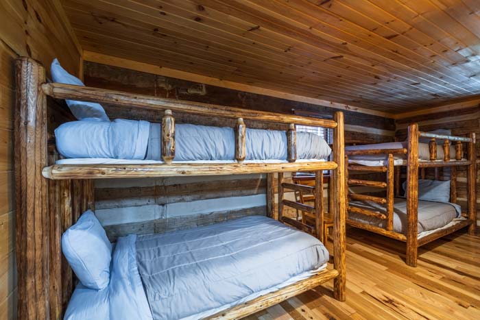 Bunk room with two sets of log bunk beds at High Point Lodge