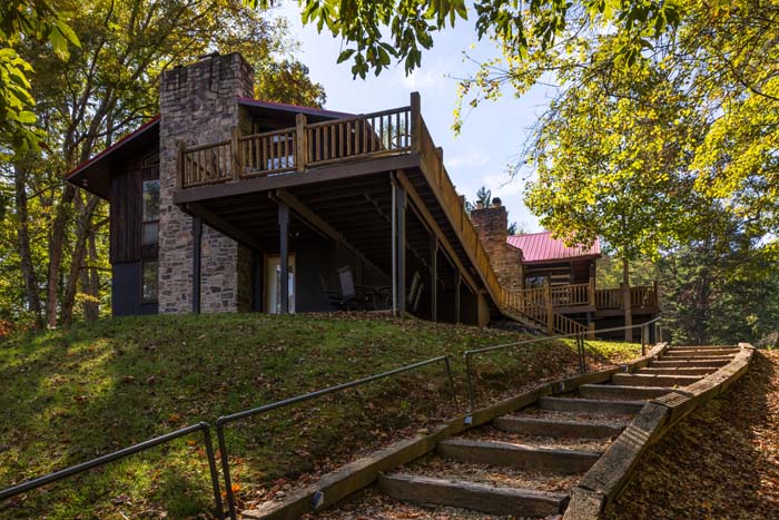 Stone steps leading up the lawn to the deck and stone chimney at High Point Lodge
