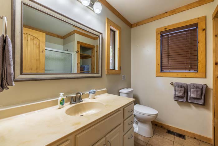 Bathroom with long vanity, mirror and toilet at High Point Lodge