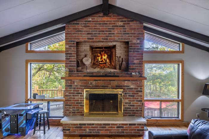 Brick fireplace with windows on each side in the family room at High Point Lodge