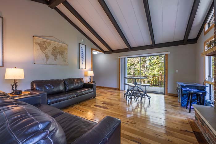 Family room with leather sofas and sliding door to the deck at High Point Lodge