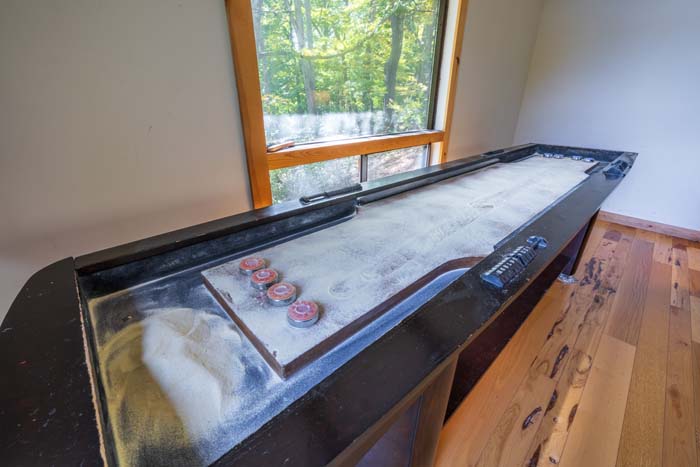 Shuffleboard table by the windows at High Point Lodge