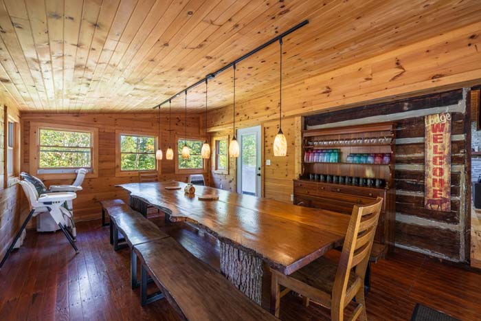 Long live edge dining table with benches in the pine dining room at High Point Lodge