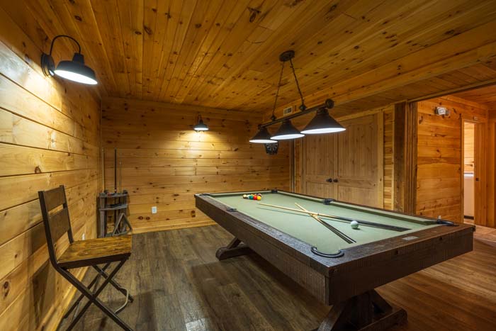 Game room with pool table and pendant lights at High Point Lodge