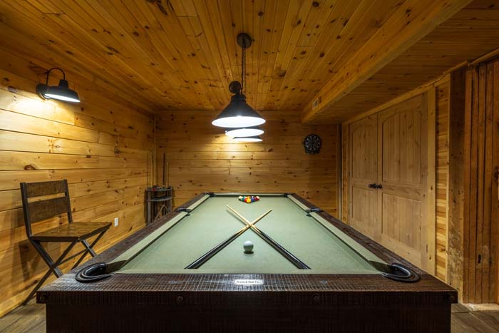 Pool table under pendant lights in the game room at High Point Lodge