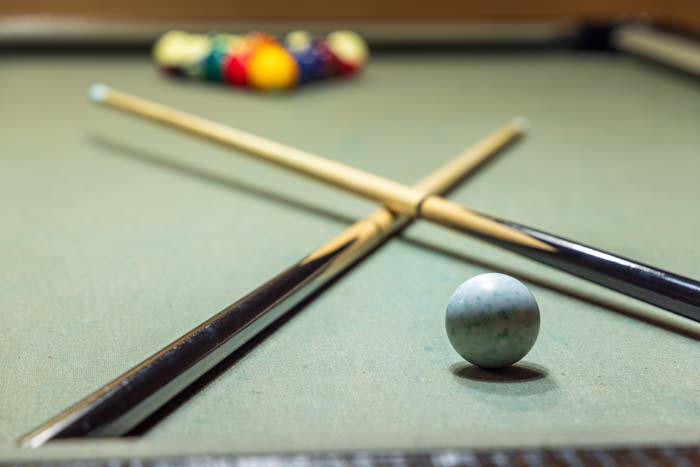 Pool cues and cue ball on the pool table at High Point Lodge