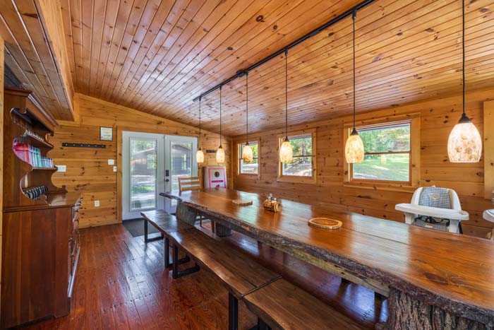Dining room with live edge table, pendant lights and French doors at High Point Lodge