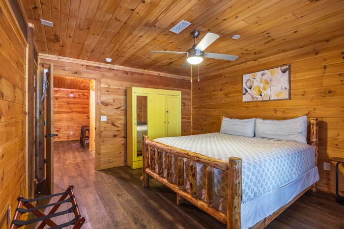 Bedroom with log bed and doorway to the hall at High Point Lodge