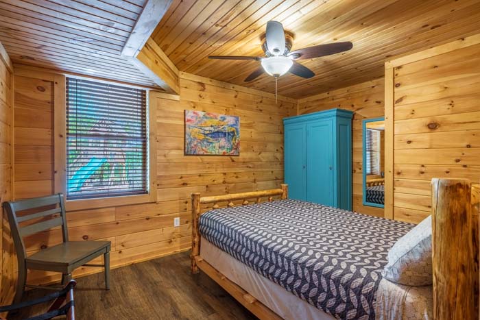 Bedroom with log bed and teal armoire at High Point Lodge