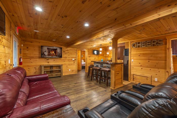 Lower level family room with recliners, red leather sofa and bar at High Point Lodge