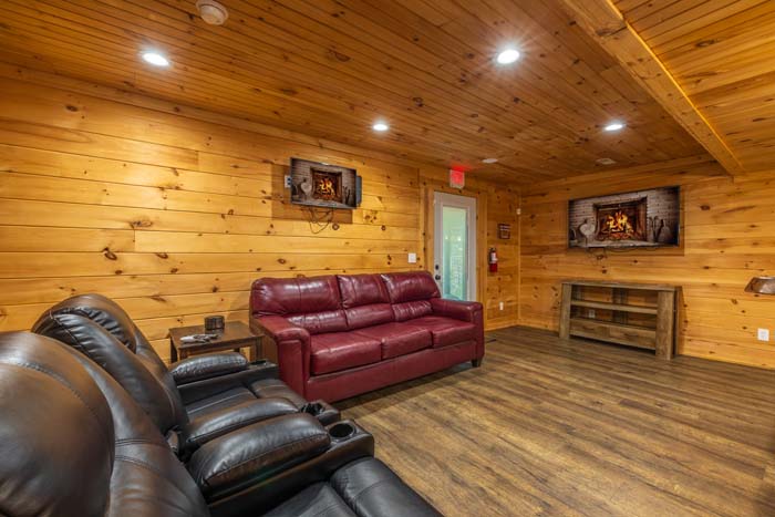 Lower level lounge with theater recliners and red leather sofa at High Point Lodge