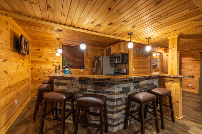 Second kitchen with stone breakfast bar and bar stools at High Point Lodge