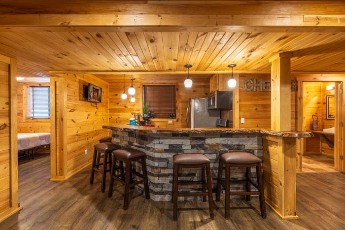 Lower level kitchen and stone bar with bar stools at High Point Lodge