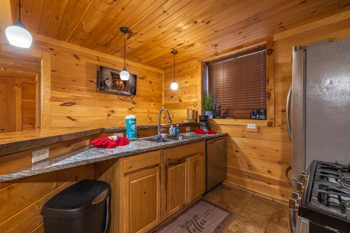 Second kitchen with granite counters and stainless refrigerator at High Point Lodge