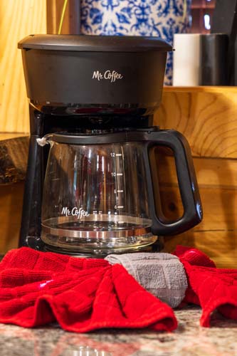 Coffee maker and red towels on the counter at High Point Lodge