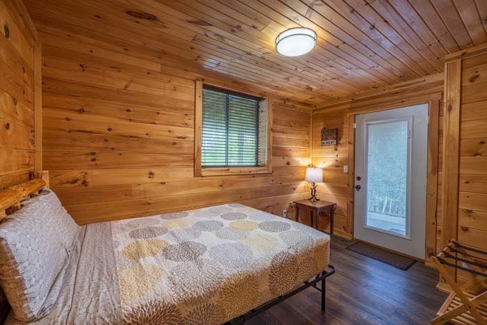 Bedroom with bed and outside door at High Point Lodge